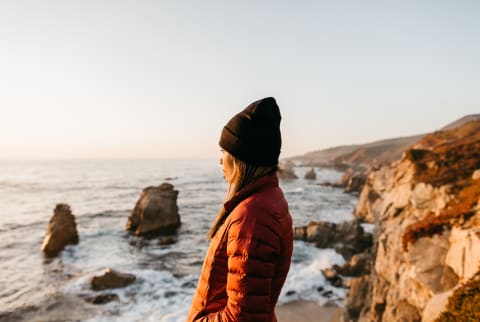 Woman looking out enjoying the view of the Pacific Ocean off of California’s central coast.