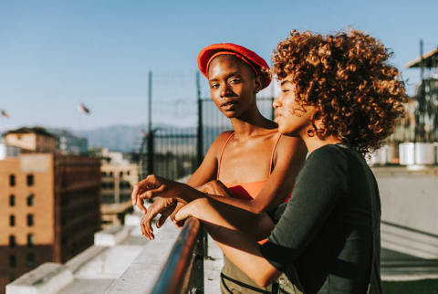 Two Friends Soaking Up the Sun on a Rooftop