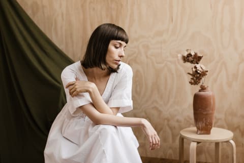 Portrait of a Thoughtful Woman on a Plywood Backdrop