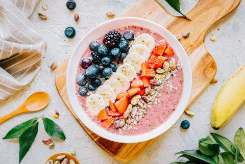 Acai smoothie bowl with blueberries, blackberries, strawberries, banana, hemp seeds and pistachio