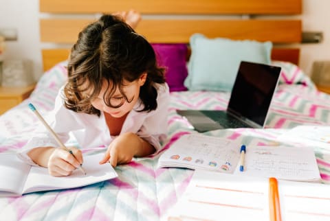 Little girl doing school homework at home