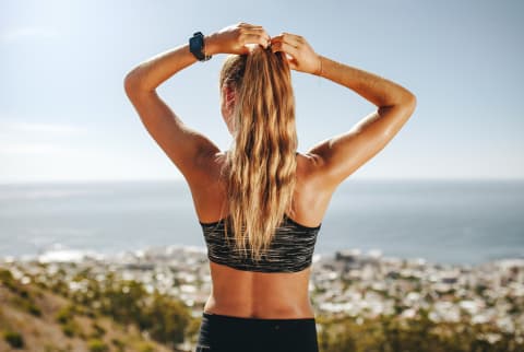 Back of a Woman in Fitness Clothing, Adjusting Her Ponytail