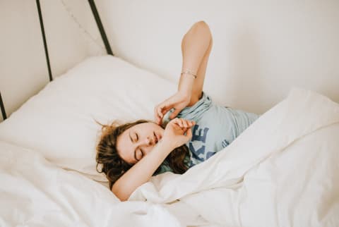 Woman Tossing and Turning in Bed