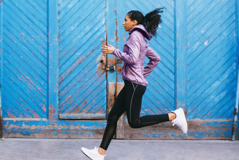 Woman running / exercising / working out outside during fall / winter