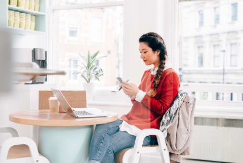 Woman Texting on her Phone at Work