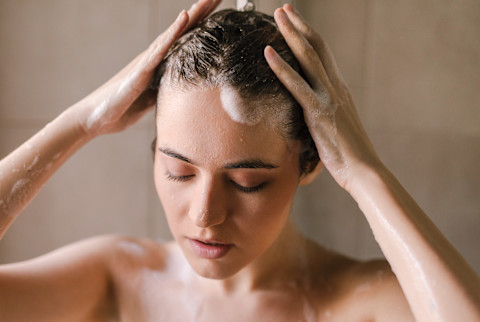 Woman Washing Her Hair in the Shower Woman Washing Her Hair in the Shower