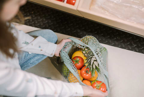 Woman Grocery Shopping with Reusable Bag