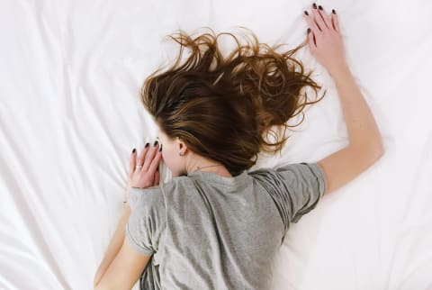 Woman Sleeping in Bed