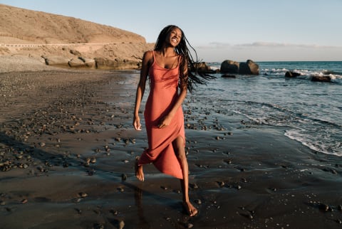 Smiling Woman Running on the Beach