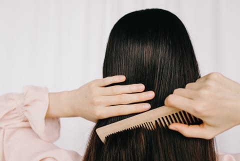 Woman Combing Her Hair