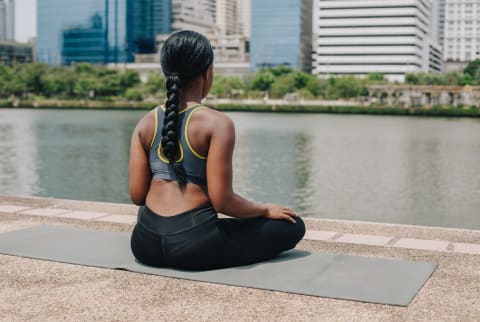Woman Meditating Outdoors on a Yoga Matt