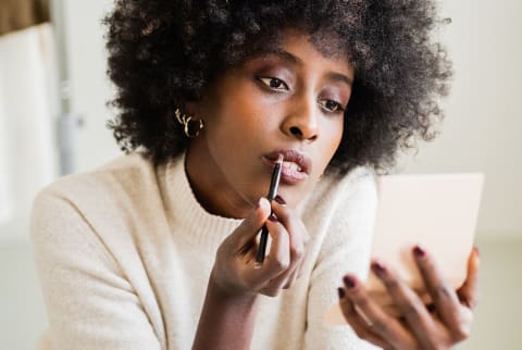 Young Woman Applying Makeup