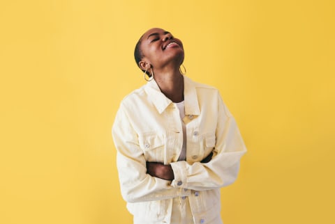 Happy Woman Wearing Yellow on a Yellow Background