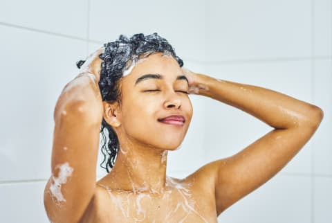 woman washing her curly hair