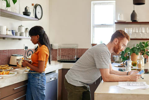 Couple in a Kitchen Doing Different Things