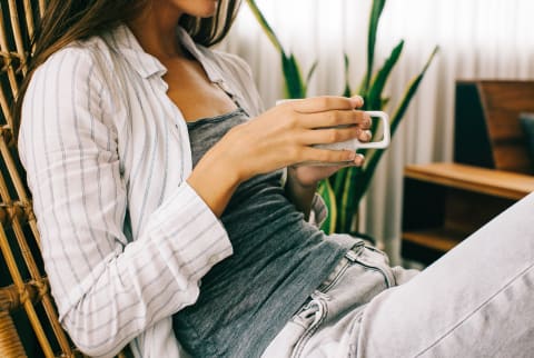 Unrecognizable Woman Relaxing At Home Drinking Tea