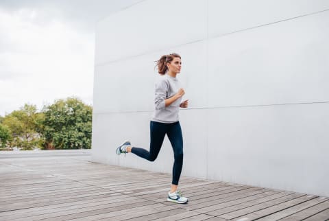 Woman Running Outdoors In Cool Weather