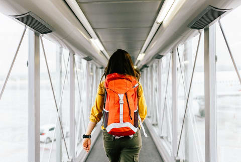 Woman Walking to Airplane Gate at Airport