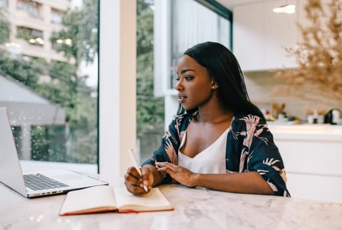 woman at computer thinking