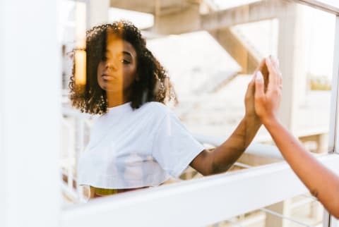 Woman Gazing at Her Reflection Outdoors