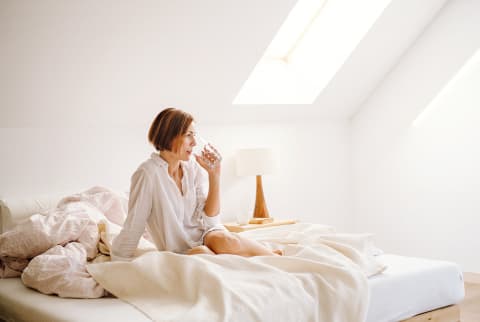 Woman Waking Up In The Morning and Drinking a Glass of Water