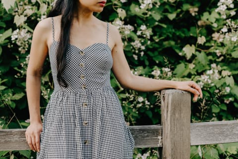 Unrecognizable Woman in a Gingham Dress Outdoors