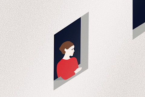 Lonely woman looking out window