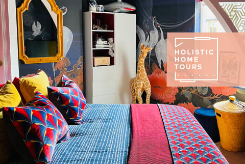 vibrant bedroom with giraffe figure and lots of colors and prints