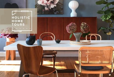 white dining table surrounded by wood and wicker chairs