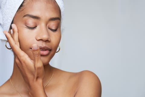 Woman Applying Skincare to Face