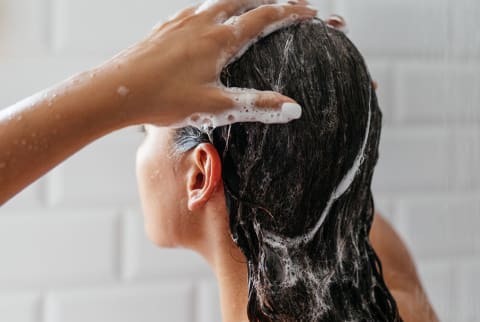 woman washing hair in shower