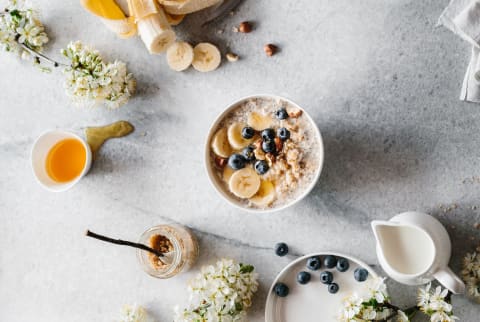 healthy fruit oatmeal bowl with bananas and blue berries