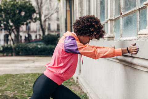 Young African American Woman Doing Stretching Exercises In The Park.