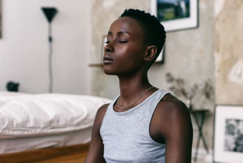 Woman Meditating at Home