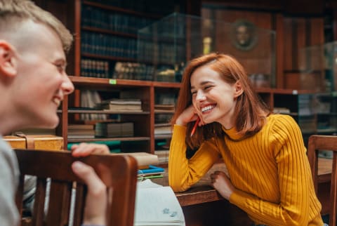 Young Folks Flirting in a Library