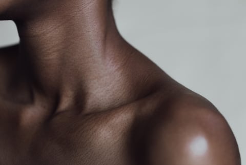 Close up shot of a woman's neck, collarbone, and shoulder