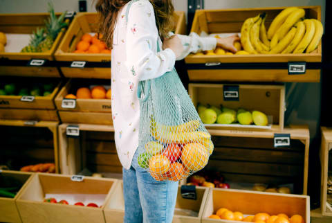 Woman intermittent fasting picking up some fruit