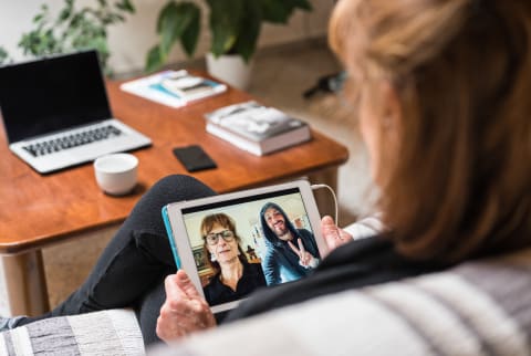 Woman Having A Video Call With Distant Family Using A Digital Tablet
