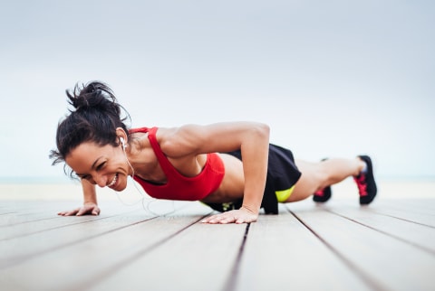 stock image of woman doing push up smiling