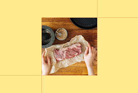 photo of raw steak on counter on yellow background photo of raw steak on counter on yellow background