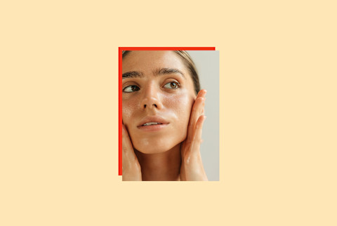 photo of woman applying skin care to her face on yellow background