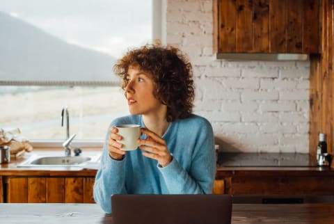 Beautiful Young Woman Drinking Tea And Working Remotely