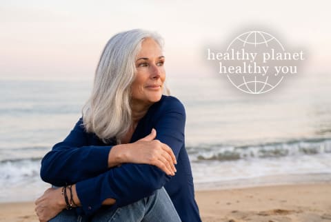 older woman on the beach with Healthy Planet Healthy You text