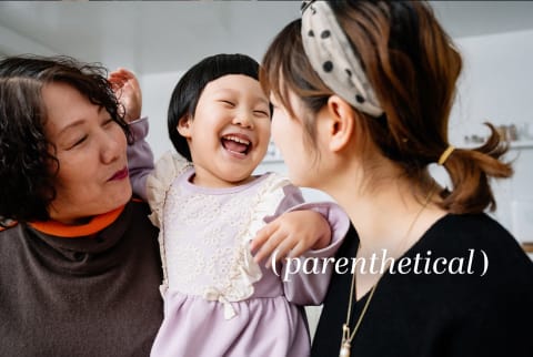 Child smiling with her mother and grandmother, Parenthetical Franchise