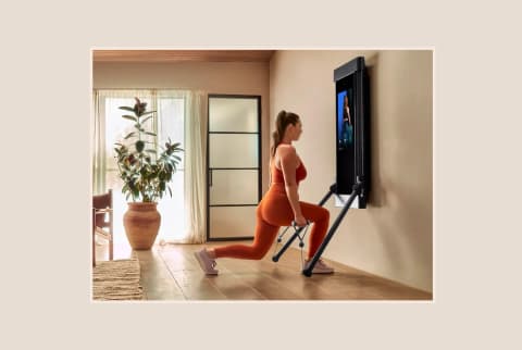 Woman Using Tonal Workout Mirror In Home