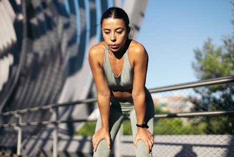 Woman out of breath from running Woman out of breath from running