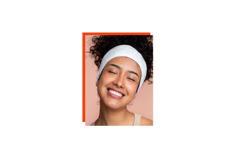 close up of woman smiling with headband on