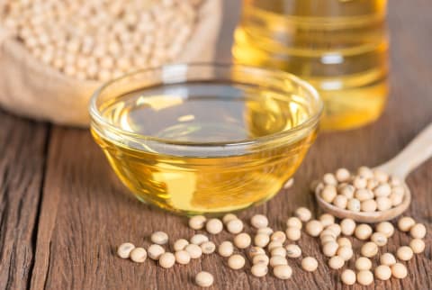 Soybean oil and Soybean on wooden table