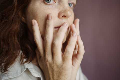 Beautiful Woman with freckles on face and hands