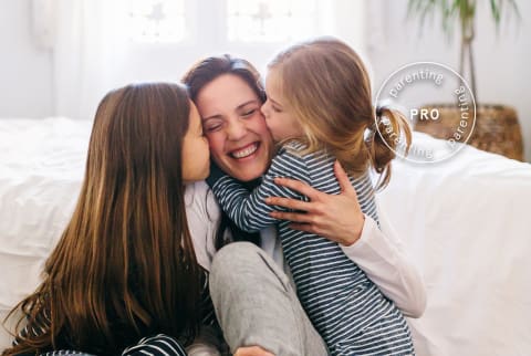 Happy mother with daughters Pro Parenting